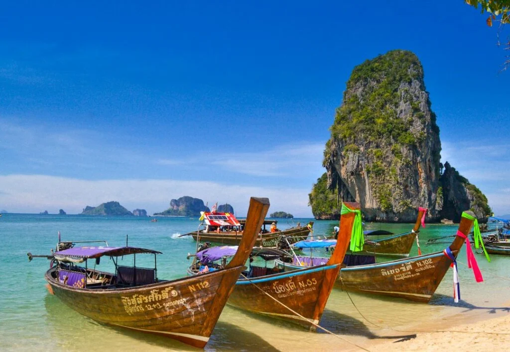 Longtail boats beside a tropical coast in Thailand