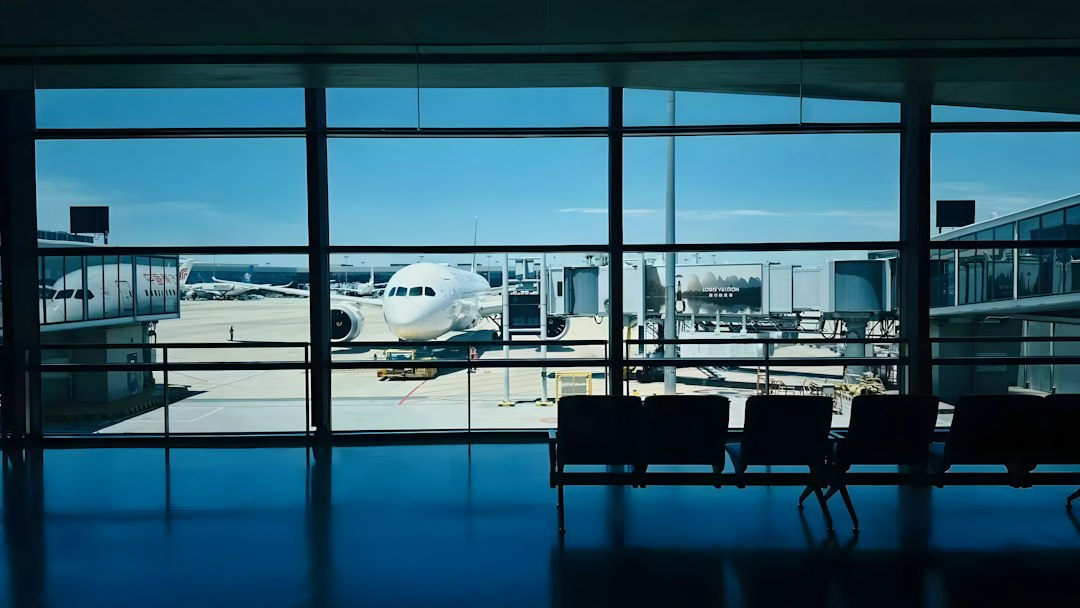 An aircraft at the gate, seen through an airport terminal window