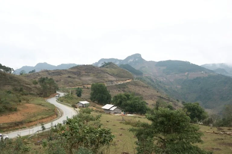 A road through a green mountain valley in the Ha Giang region